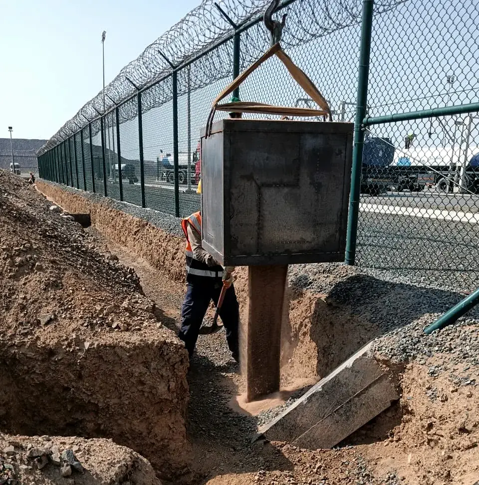 Lowering a precast chamber into the trench