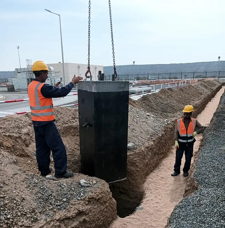 Crew guiding a chamber into place
